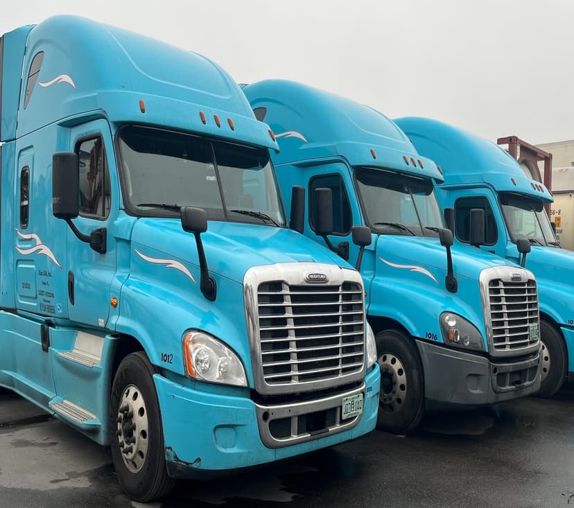 Three light blue trucks